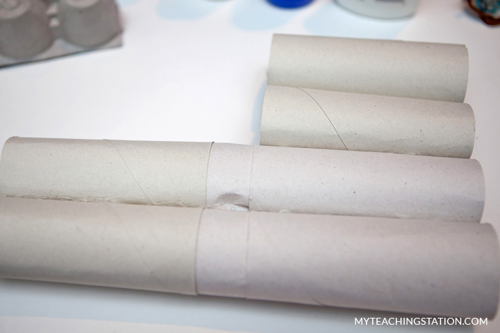 Add hot glue to attach toilet paper rolls together.