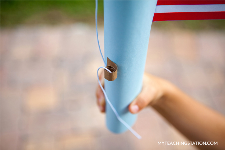 Add pole string holder onto the paper towel roll.